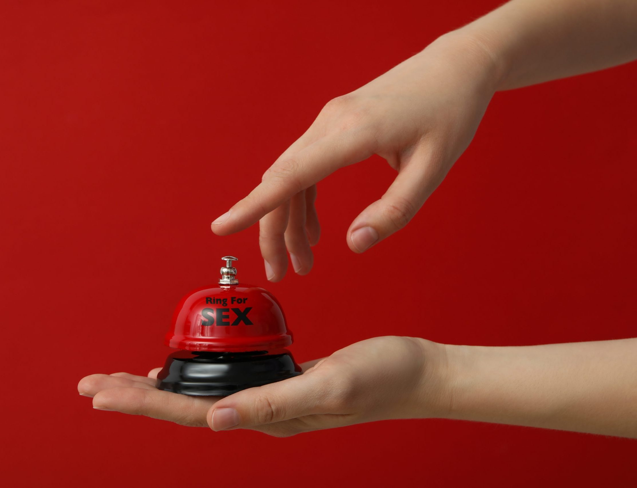 Bell,For,Sex,On,A,Red,Background.